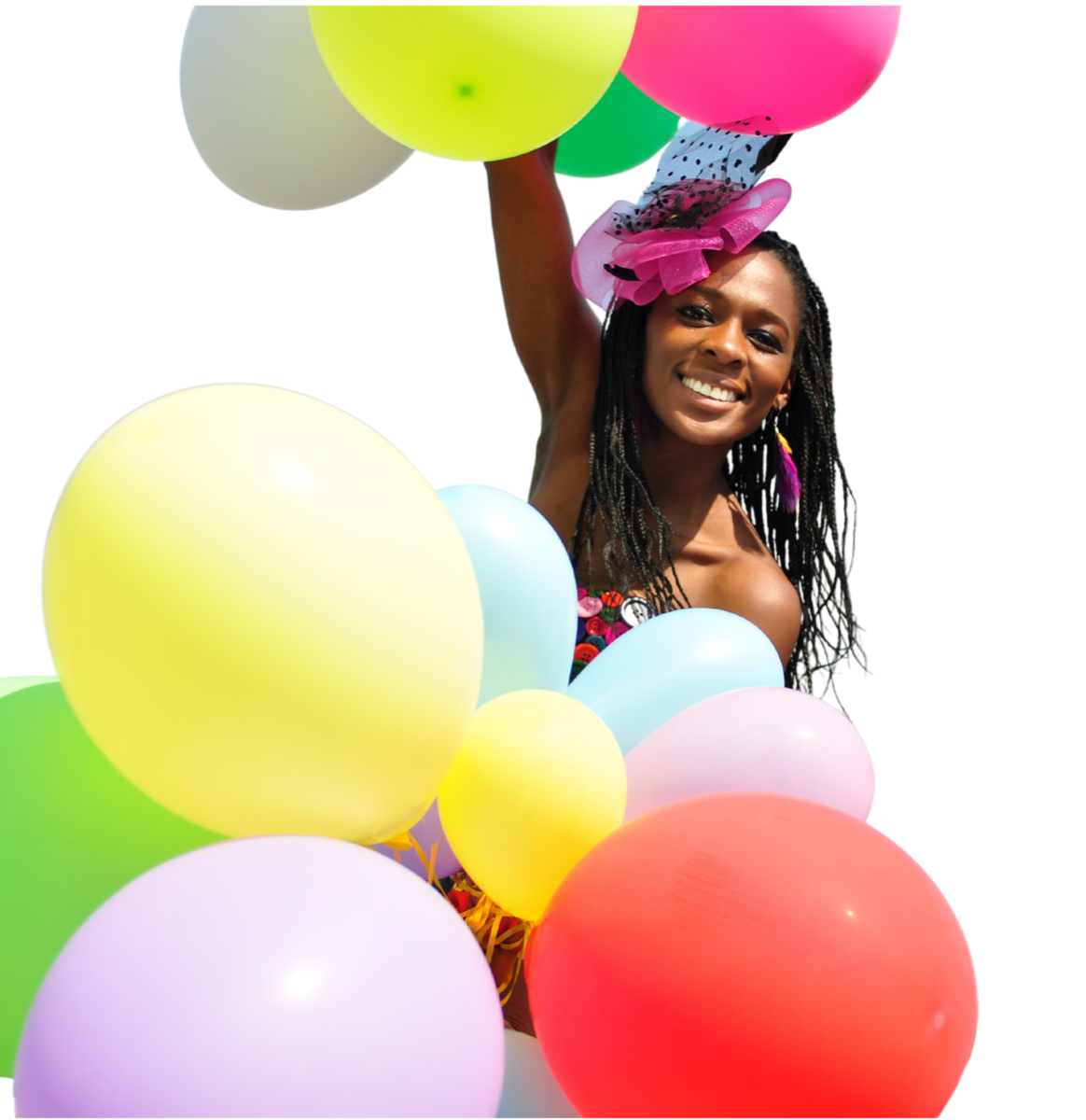 A smiling person in a party hat holding colourful balloons